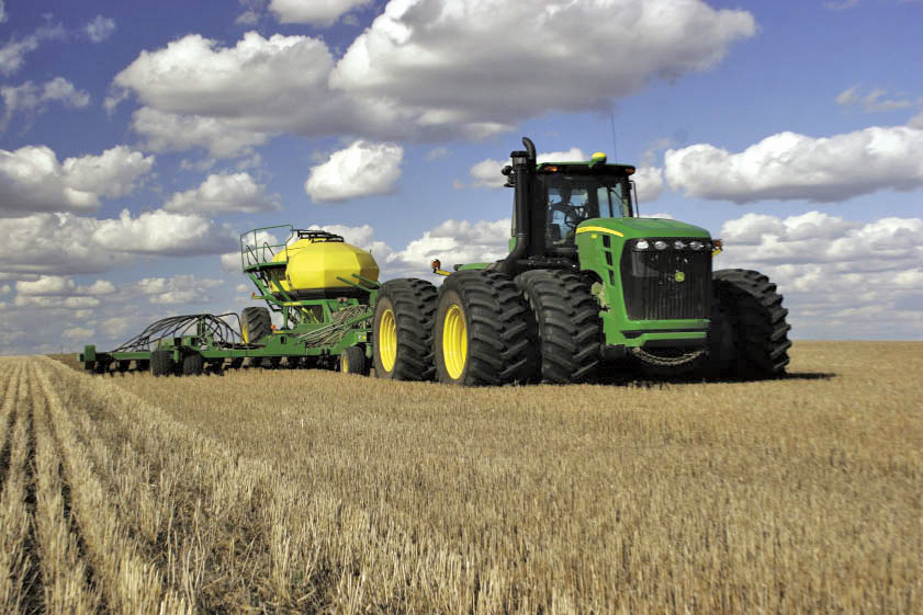 The tractor operator holds up his hands