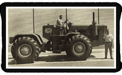 This 1964 photo shows a very young Charlie Gause, a territory manager in Kansas, posing in front of a John Deere model 8020 as dealer Bob Morton gets ready to take Deere’s first four-wheel drive tractor for a test ride. List price of this unit was $33,000 and was leased to a customer near Yates Center, Kan. This 1964 photo shows a very young Charlie Gause, a territory manager in Kansas, posing in front of a John Deere model 8020 as dealer Bob Morton gets ready to take Deere’s first four-wheel drive tractor for a test ride. List price of this unit was $33,000 and was leased to a customer near Yates Center, Kan.