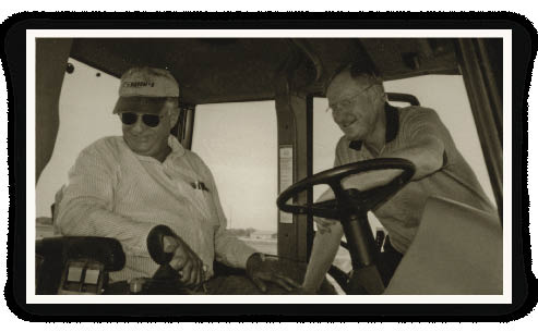 At a customer event in 2002, Allen Rider, vice president of New Holland North T American Agriculture (rt), talks about the features of the company&rsquo;s newest offer- &ldquo; ing in its Ford Genesis tractor lineup.