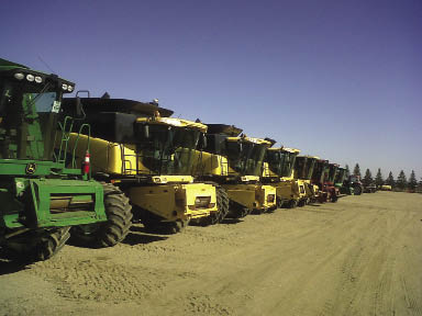Used Combines on Farm Equipment Dealer Lot Used Combines on Farm Equipment Dealer Lot