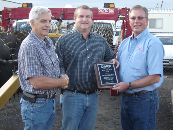 Karl Almquist, general manager of Nikkel Iron Works, presents the DARF Top Dealer Award to Doug Ottersberg, general sales manager of Agri-Service, along with Brett Mathie, area sales representative for Nikkel Iron Works.)