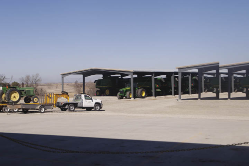 In the back lot of Hiawatha Implement’s new store sits two 70 x 160 foot covered stalls for storing used equipment and equipment waiting for service. 